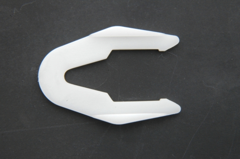 Koplamphoogtebediening: borgklem wit plastic.